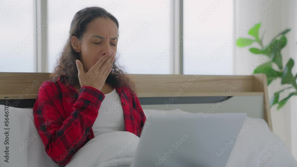 Black african american woman work tired exhausted, Businesswoman or freelancer was exhaustion, drowsiness on bed while working remotely or studying on laptop at home office, overworked, needs rest. Black african american woman work tired exhausted, Businesswoman or freelancer was exhaustion, drowsiness on bed while working remotely or studying on laptop at home office, overworked, needs rest.