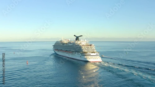 Cruise ship sailing across The Mediterranean sea - Aerial footage. Aerial view of a beautiful white cruise liner in a sunny day. Luxury cruise in the ocean sea concept tourism travel.  photo
