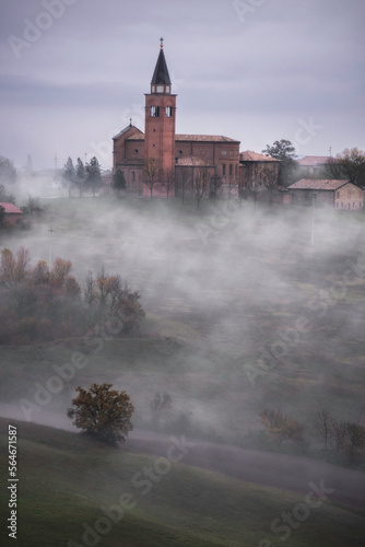 church in the fog in the italian countryside