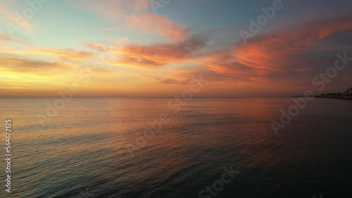 Idyllic sunrise over calm smooth waters of Mediterranean Sea. Sunny morning glow. Travel and tourism concept