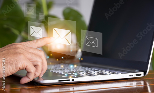 Businessman using laptop with email icon, online communication concept, coordination, online transaction. photo