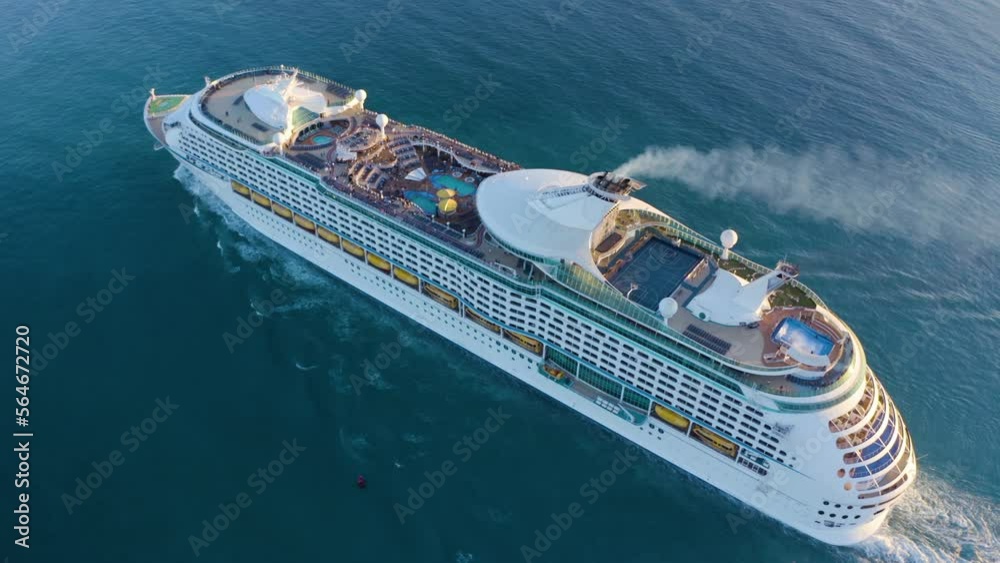 Cruise ship sailing across The Mediterranean sea - Aerial footage. Aerial view of a beautiful white cruise liner in a sunny day. Luxury cruise in the ocean sea concept tourism travel. 