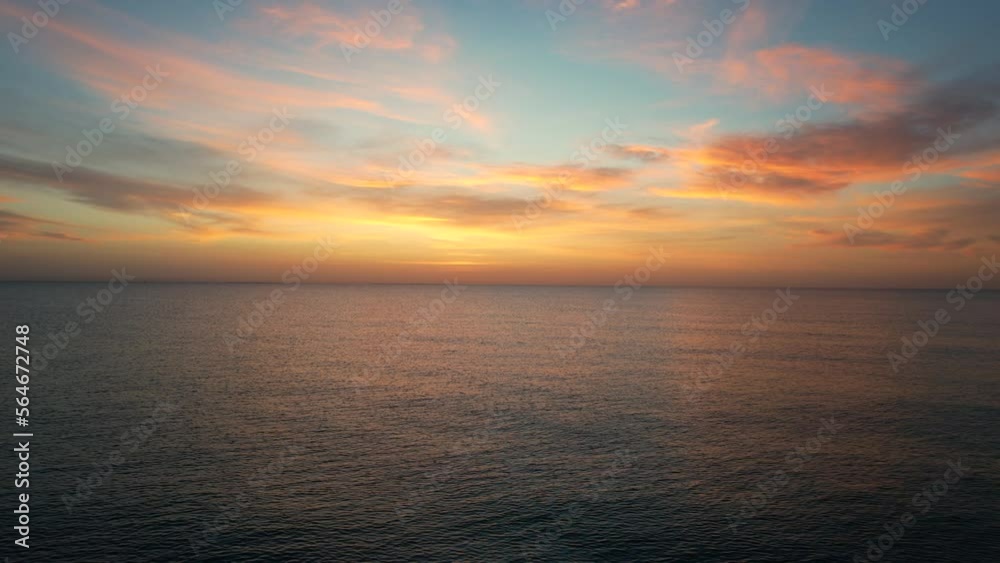 Picturesque sunrise over calm smooth waters of Mediterranean Sea. Sunny morning glow. Travel and tourism concept