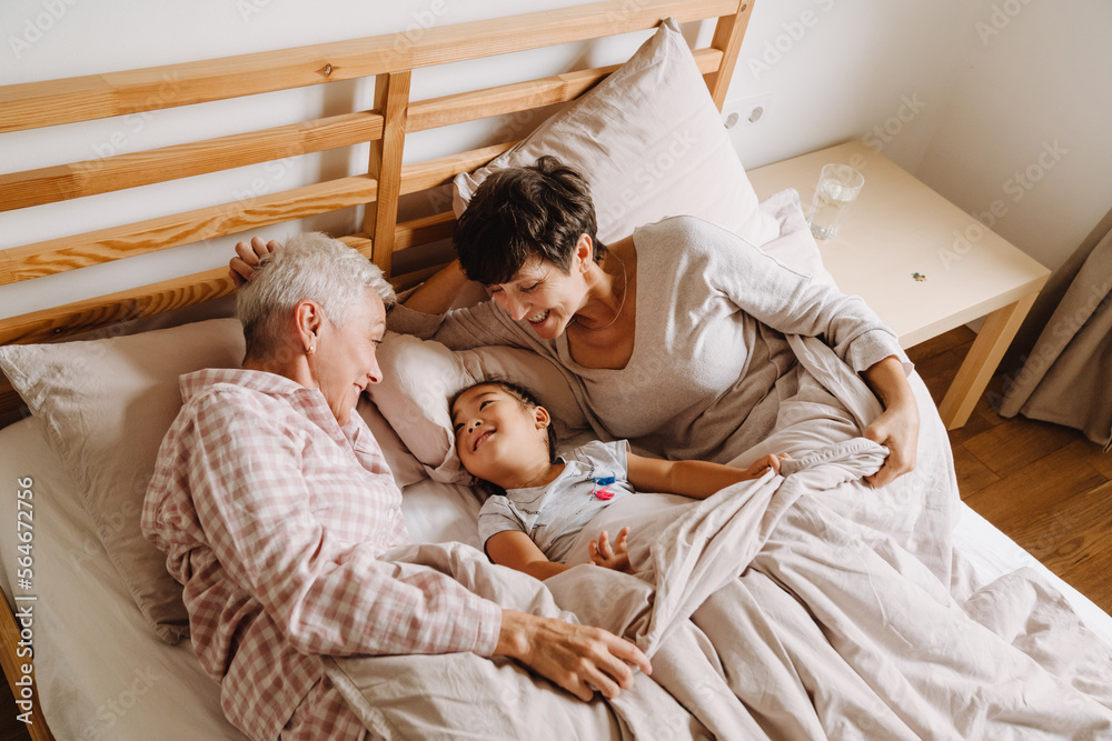 Happy mature same sex couple with adopted asian little girl Happy mature same sex couple with adopted asian little girl