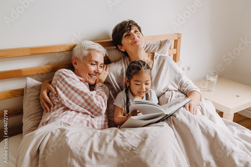 Canvas Print Happy mature same sex couple with adopted asian little girl