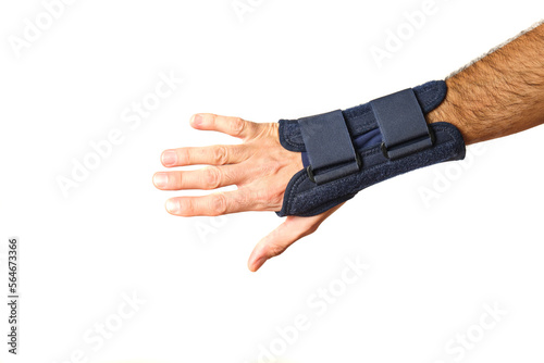 man's hand with therapeutic wrist brace to relieve wrist sprain pain on pure white background