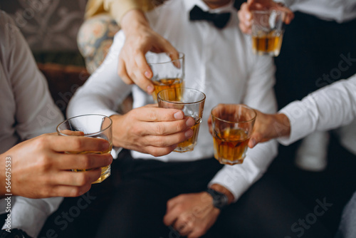 Business meeting. Men hold glasses of whiskey. Men s Party. Hand with a drink of alcohol.