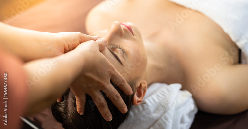 happy beautiful caucasian woman enjoying head massage at the spa and wellness center © NVB Stocker