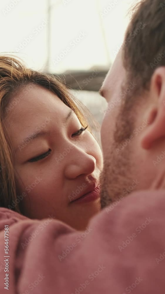 VERTICAL VIDEO: Close-up of young happy couple sitting in seaport VERTICAL VIDEO: Close-up of young happy couple sitting in seaport