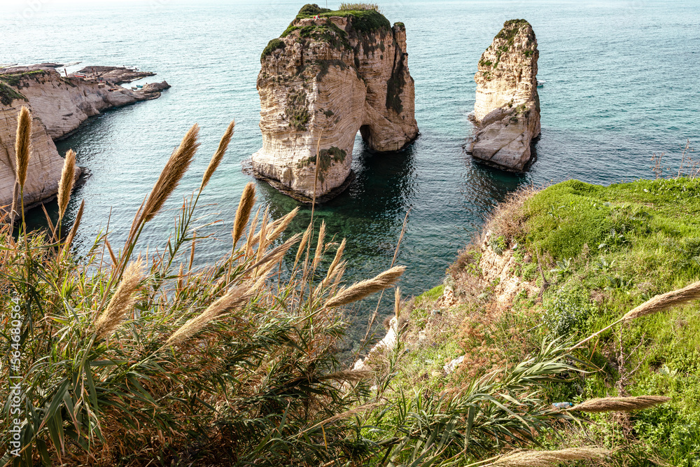 Naklejka premium Raouche Rocks in Beirut, Lebanon in the sea during daytime. Pigeon Rocks in Mediterranean Sea. Popular Tourist Destination in Beirut. 