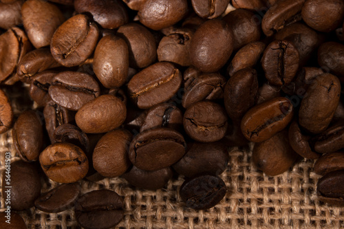 Coffee beans spilled out of the jar onto the table in the kitchen 

