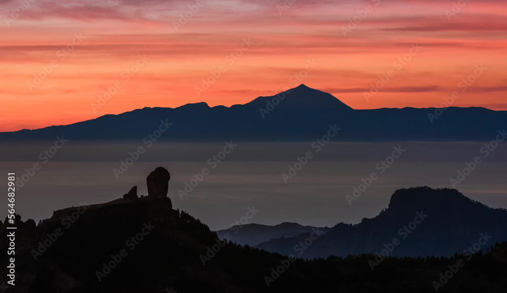 Magic view of Roque Nublo and the magestic Teide peak on the island of Tenerife in the background at sunset, Roque Nublo Rural Park, Gran Canary, Canary Islands, Spain