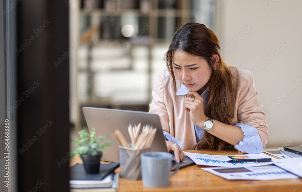 Thai Asian businesswoman working inside office with documents and laptop, worker paperwork calculates financial indicators smiling and happy with success and results of achievement and work
