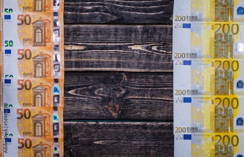 Euro banknotes on a wooden background with a place to copy. photo