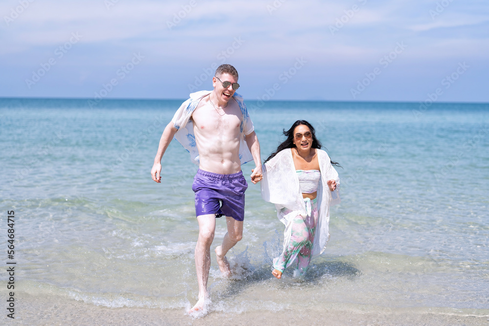 Love couple on holiday happy playing running along the beach and sweet kiss on love emotion Love couple on holiday happy playing running along the beach and sweet kiss on love emotion
