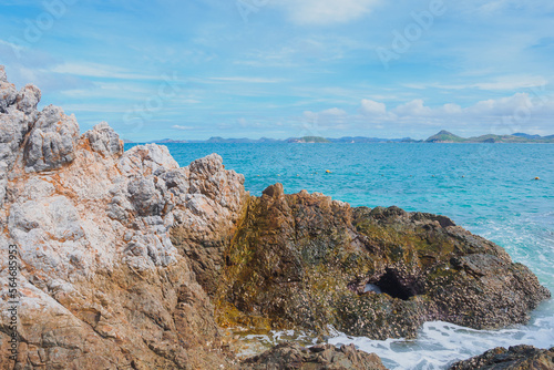 Rock on the beach with emerald sea and clear blue bright sky with copy space at Kham Island (Koh Kham), Chonburi, Thailand