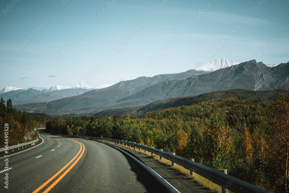 Empty road with a view on majestic mountains and the norwegian landscape in autumn Empty road with a view on majestic mountains and the norwegian landscape in autumn