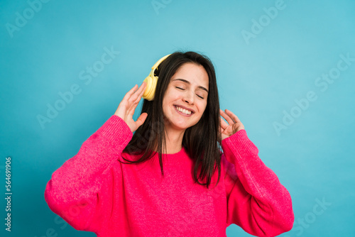 Smiling woman in headphones and listening music