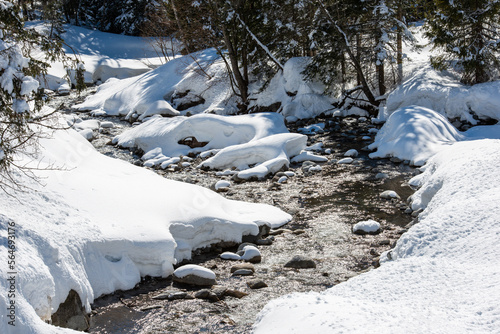  frozen river with snow covered rocks