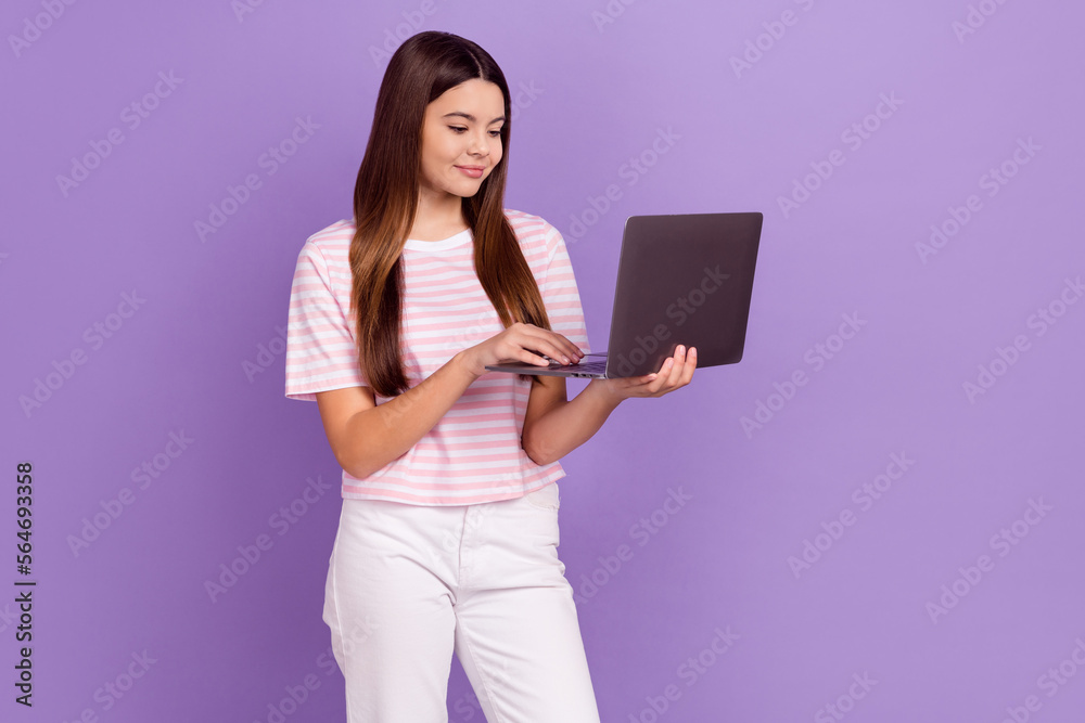Photo of cute pretty lady wear striped white t-shirt preparing tasks modern gadget empty space isolated violet color background Photo of cute pretty lady wear striped white t-shirt preparing tasks modern gadget empty space isolated violet color background