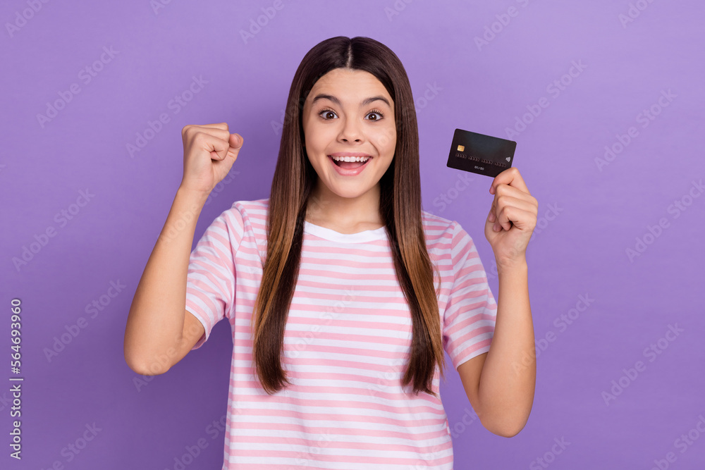 Photo of charming lucky lady wear striped white t-shirt earning first money bank card isolated violet color background Photo of charming lucky lady wear striped white t-shirt earning first money bank card isolated violet color background