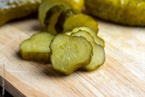 Pickled cucumbers on a wooden table during cooking