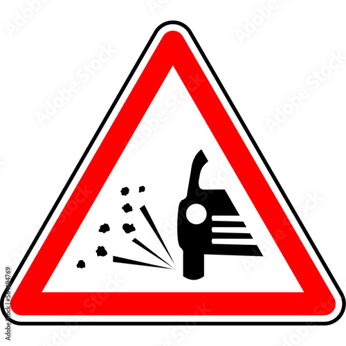 Red and black vector graphic of a loose chippings sign. The sign consists of a red warning triangle with the silhouette of a car throwing up gravel chippings