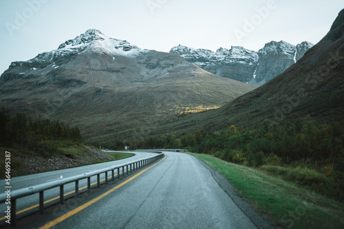 Empty road with a view on majestic mountains and the norwegian landscape in autumn