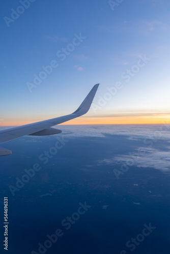 Beautiful sunset, sky on the top view, airplane flying view from inside window aircraft of Traveling vertical image..