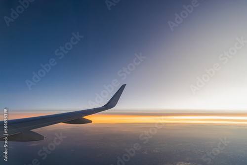 Beautiful sunset, sky on the top view, airplane flying view from inside window aircraft of Traveling..