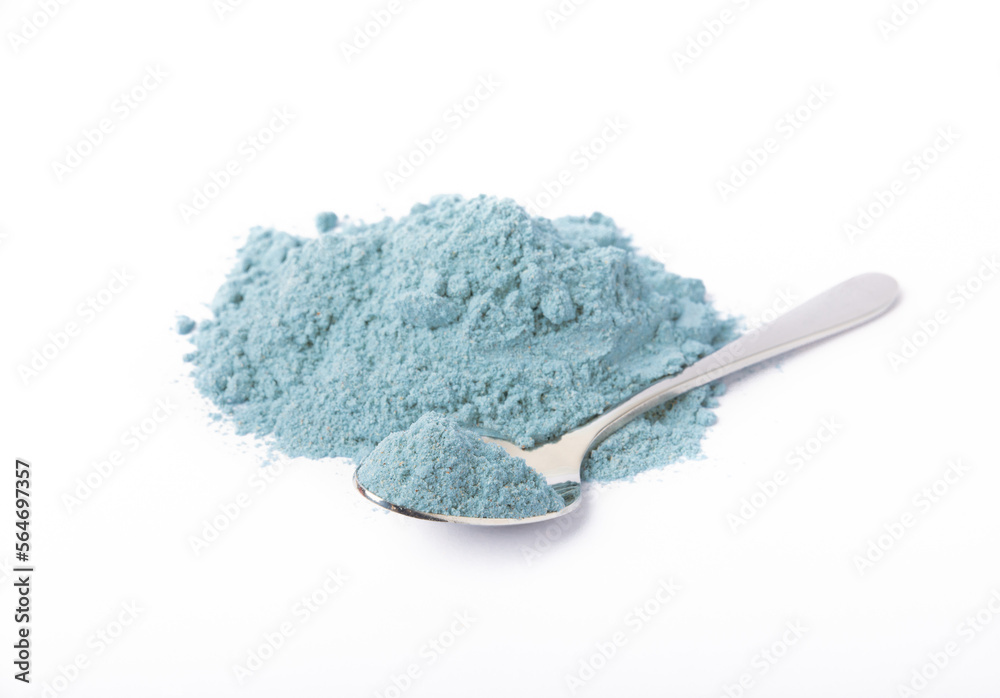 Blue spirulina powder in spoon isolated on white background. Natural vegan superfood. food supplement. Blue spirulina powder in spoon isolated on white background. Natural vegan superfood. food supplement.