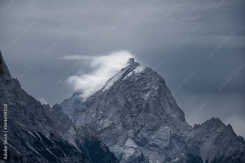 snow covered mountain and clouds