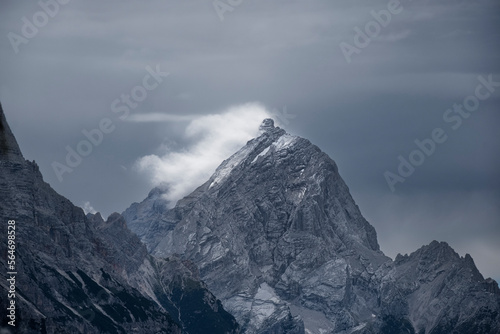 snow covered mountain and clouds