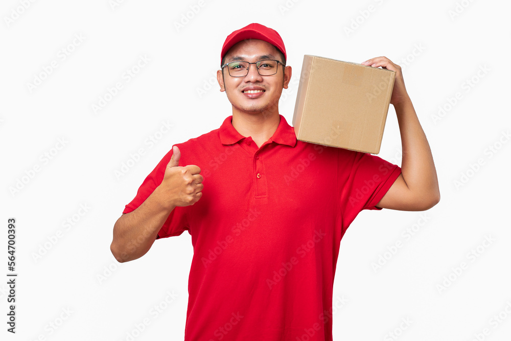 Smiling asian courier delivery man in red cap and t-shirt hold package on shoulder, make thumb-up Smiling asian courier delivery man in red cap and t-shirt hold package on shoulder, make thumb-up