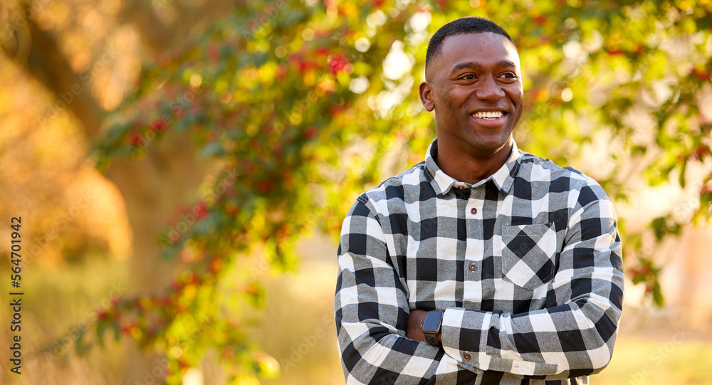 Head And Shoulders Portrait Of Smiling Man Outdoors In Countryside