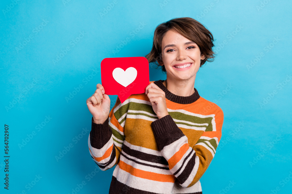 Photo of cheerful positive woman dressed striped pullover rising heat like card smiling isolated blue color background Photo of cheerful positive woman dressed striped pullover rising heat like card smiling isolated blue color background
