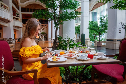 Woman Enjoying breakfast meal in Luxury Restaurant in modern resort or hotel © TravelMedia