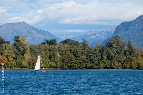 sailboat on the lake with mountain background