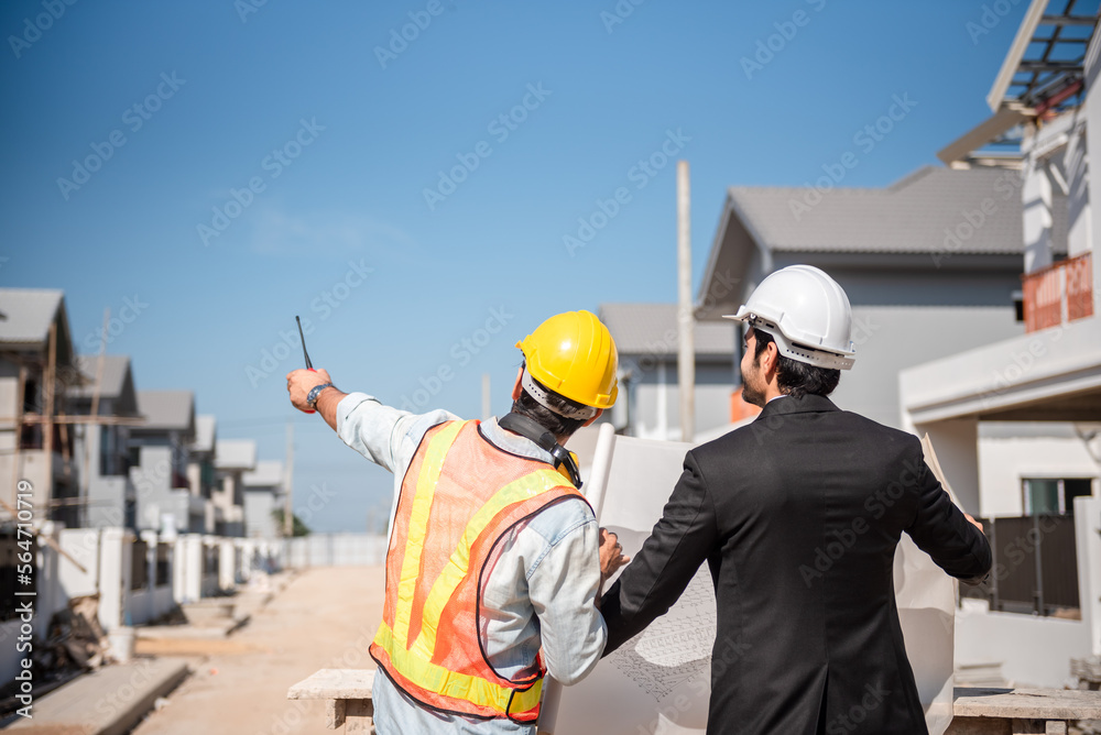 Professional civil engineer and architect in safety helmet hard hat working together in construction site, two men discuss about real estate project or production in industry