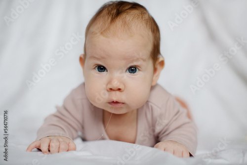 portrait of a smiling baby lying on his stomach. High quality photo