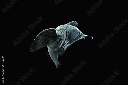 Helmet with wings of Hermes (Mercury). Fragment of an ancient statue on black background. photo