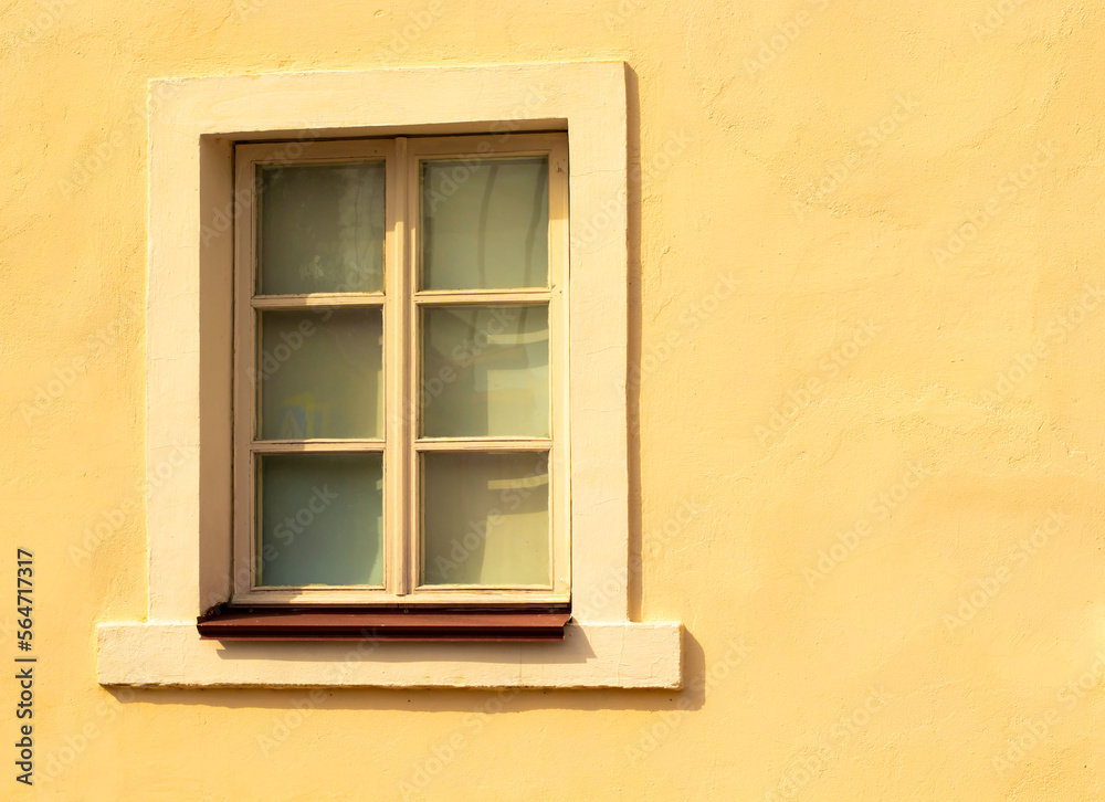 little old window in yellow wall little old window in yellow wall