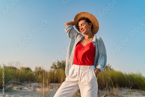 stylish attractive woman on beach in summer style fashion trend outfit happy having fun