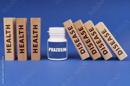 Medical concept. On a blue background, wooden dies, a white jar with the inscription - Prazosin photo