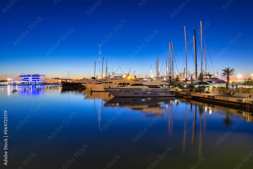 Night landscape of the Port of Valencia with the yacht harbor, Spain.