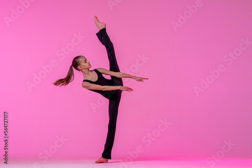 Tableau sur toile teenage girl in a tight black costume dancing a modern contemporary contemporary dancer isolated on a background in neon light