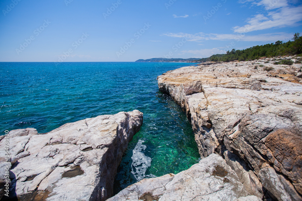 View of summer nature landscape, turquoise color of beautiful Aegean sea, summer day. Rocky shore. Summer holiday vacation destination. Greece 	