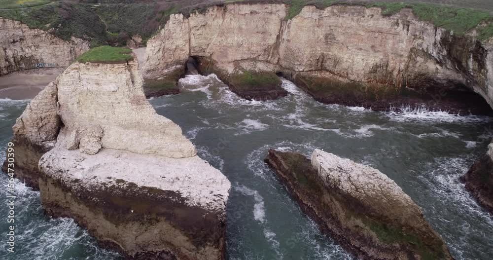 Shark Fin Cove Beach with a Towering rock and Sea Cave. California. Pacific Ocean Waves. Island. Drone Shark Fin Cove Beach with a Towering rock and Sea Cave. California. Pacific Ocean Waves. Island. Drone