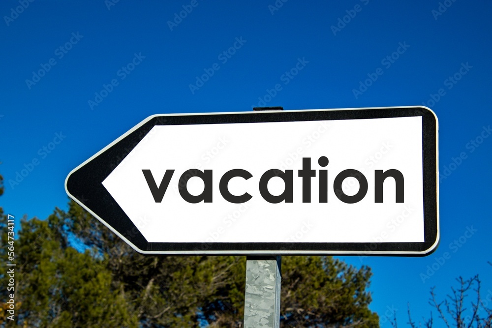 the word 'vacation' written on a road sign