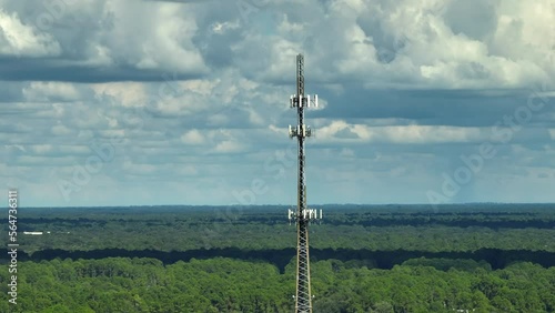 Aerial view of telecommunications cell phone tower with wireless communication 5g antennas for network signal transmission